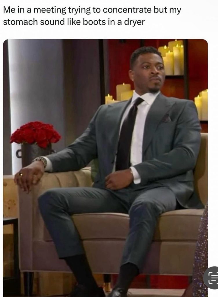 Man trying to concentrate in meeting with stomach noises