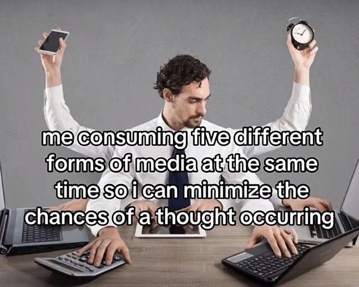 Man consuming multiple media forms